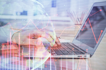 Double exposure of stock market graph with man working on laptop on background. Concept of financial analysis.