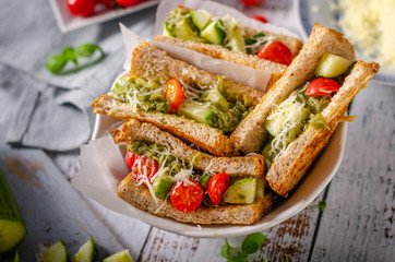 Healthy toast with vegetables, pesto and cheese