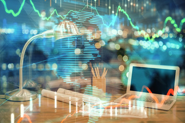 Financial graph colorful drawing and table with computer on background. Multi exposure. Concept of international markets.