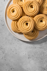 Cookies on a white ceramic tray on the gray kitchen table. Top view with copy space	