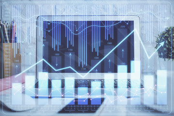 Financial chart drawing and table with computer on background. Multi exposure. Concept of international markets.
