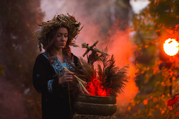 Woman sitting in burning pentagram circle, magic.