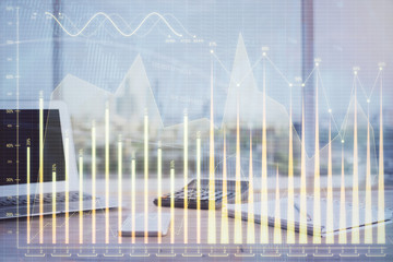 Stock market graph on background with desk and personal computer. Double exposure. Concept of financial analysis.