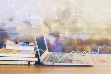 Forex market graph hologram and personal computer on background. Double exposure. Concept of investment.