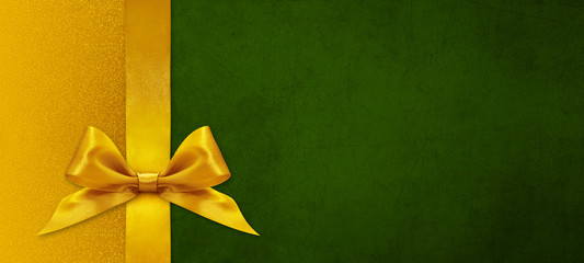 gift card wishes merry christmas background with golden ribbon bow on green shiny vibrant color texture template with blank copy space