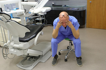 Tired mature dentist with eyes problem. Having short break for regeneration after long working...