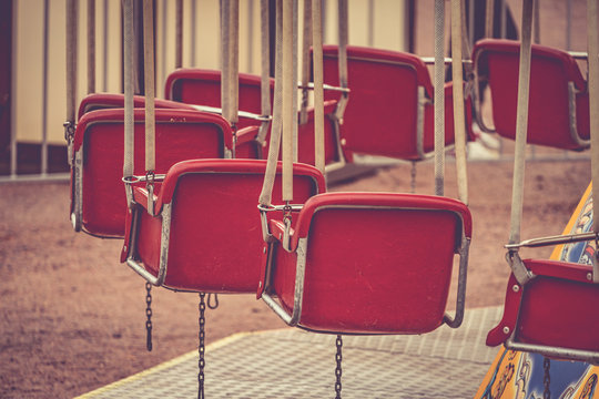 Carousel with the red vintage empty seats in a park