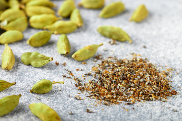Ground cardamom seeds and whole pods close-up. Seasonings and spices. Selective focus	