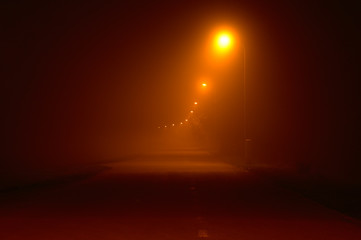 Path in heavy fog. Black and orange long exposure night panorama