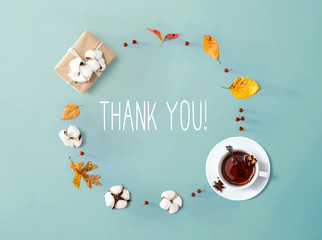 Fototapeta na wymiar Thank you message with autumn leaves and cinnamon tea