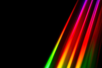 Colourfull burst of prismatic light creating lines of blured motion against a black background