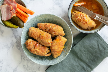 Pork slips in gravy stuffed with carrot, pickled cucumber and bacon.