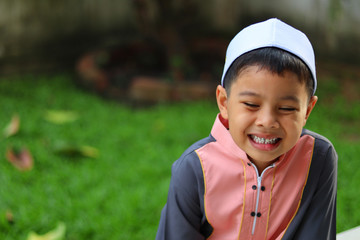 Portrait of muslim boy smiling happily. Child happy concept.