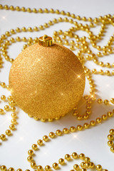 Yellow Christmas ball on the Christmas tree. shiny ball. decorations for the holiday. New year, Christmas. Yellow beads for decoration. Holiday greeting card. Ball on white background.