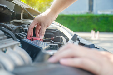 A man checking car engine, Check and maintenance the battery in car with yourself.