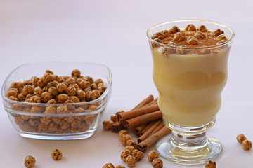 Boza in glass and lebelebi and cinnamon on it