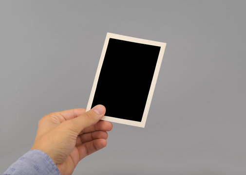hand holding blank photo frame