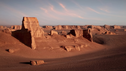 Fototapeta na wymiar Rocky formations in the Dasht e Lut desert against sunset. Nature of Iran. Persia.