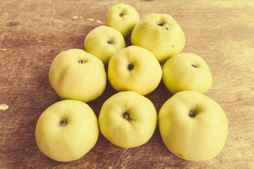 a pile of fresh juicy green apples on an old wooden surface. healthy eating and diet concept