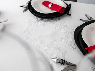 Tableware on ornamented tablecloth