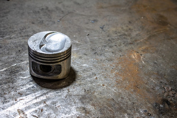 Car piston on an old metal table.