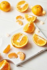 Fototapeta na wymiar Christmas oranges and tangerines on a white background by the window