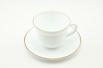 Photo of an empty white cup with a plate on a light background. The concept of lunch, breakfast.