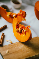 pumpkins with cinnamon sticks on marble backgrund