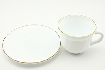 Photo of an empty white cup with a plate on a light background. The concept of lunch, breakfast.