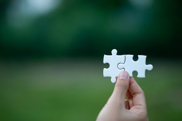 Hands and puzzles, important pieces of teamwork Teamwork concept