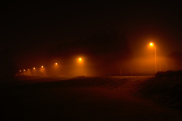 Path in heavy fog. Black and orange long exposure night panorama