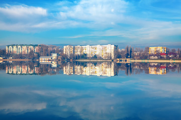 reflection of the city in the lake water 