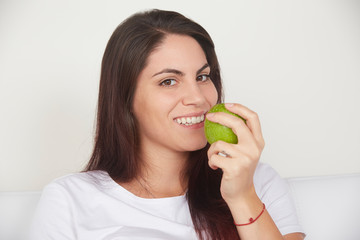 pretty woman holding green apple