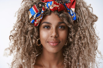 Headshot sincere, carefree attractive blond curly african-american woman in stylish headband,...