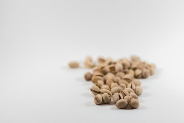 Pile of Organic Pistachios on White Background with Focus on the Front