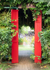 Feel fresh when walk to red door with trees wall.