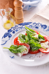salad of fresh tomatoes, young cheese and fresh spinach.