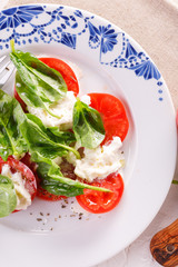 salad of fresh tomatoes, young cheese and fresh spinach.