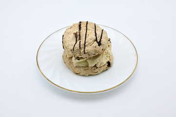 Photo on a white background of a cake on a saucer. The concept of a delicious breakfast, lunch.