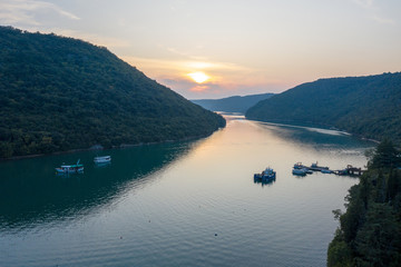 Naklejka na ściany i meble Sunset over the water channel. There is an oyster farm on the canal. Shooting from a drone. Istria, Croatia.