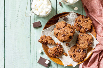 Baked Christmas cookies. Homemade Chocolate Chip Cookies on a light stone table. Top view flat lay background. Free space for your text.