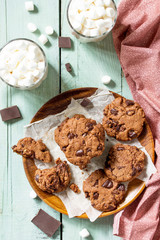 Baked Christmas cookies. Homemade Chocolate Chip Cookies on a light stone table. Top view flat lay background. Free space for your text.