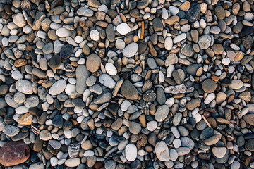 Gravel pattern of colored stones. Abstract nature pebbles background. Stone background. Sea peblles beach. Top view.