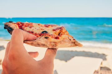 eating pizza at the beach