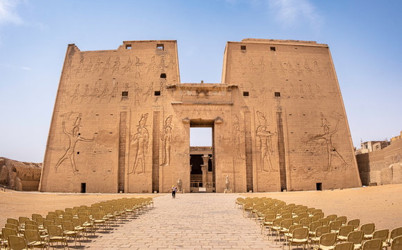 Mighty entrance (pylon) to the Ptolemaic Temple of Horus in Edfu decorated with statues of egyptian gods, Egypt