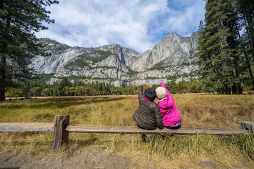 Badkamer foto achterwand Back view of active family of two, mother and  Daughter enjoying valley and mountain view in yosemite national park, california USA . Active family vacation and Travel concept © Supavadee