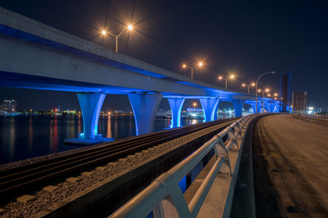 Night photo Downtown Miami port boulevard bridge lit neon electric blue