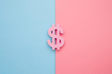 American dollar symbol on blue and pink background, minimal flatlay
