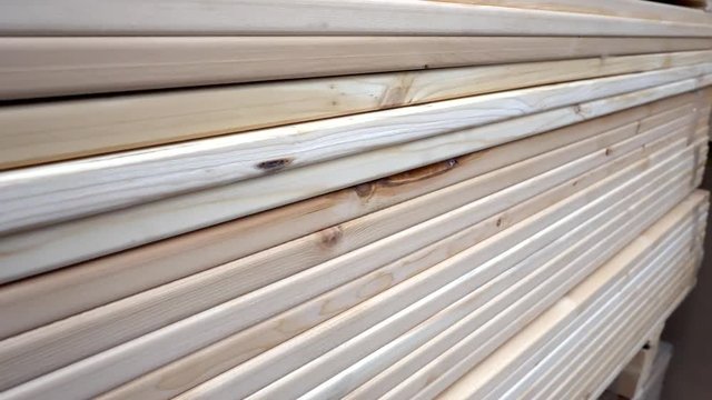 Close Up of Stacks of Wooden Planks Stored in Hardware Store. Warehouse of Finished Cut Boards. A lot of Sawn boards in Shopping Mall.