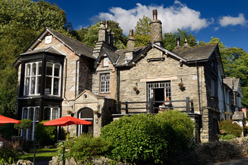 Fototapeta na wymiar Evening sun on 17th Century stone Glen Rothay Hotel and Badger Bar in Rydal Ambleside Cumbria Lake District National Park england